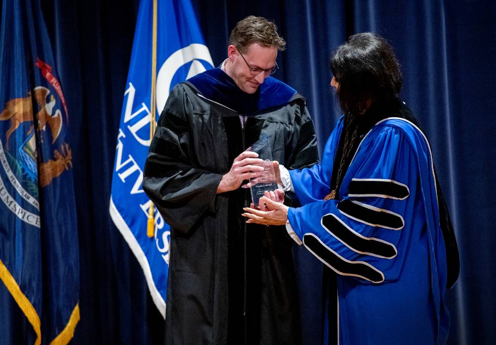 Kevin Lehnert receives his award from President Mantella